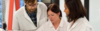 three people in lab coats