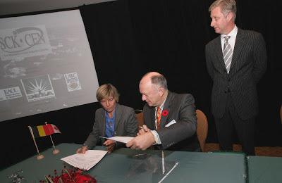 The Director of SCK-CEN, Pr. Frank De Coninck (seated) and Dr. Dominique Weis signing a Memorandum of Understanding between UBC and the Belgian Nuclear Research Centre. Prince Philippe of Belgium looks on.